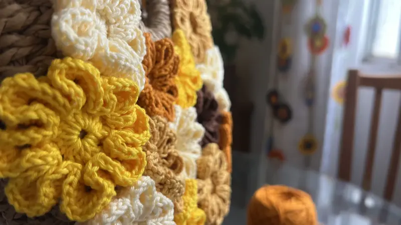 Close-up das flores em crochê com relevo tridimensional aplicadas nas tiras do chinelo